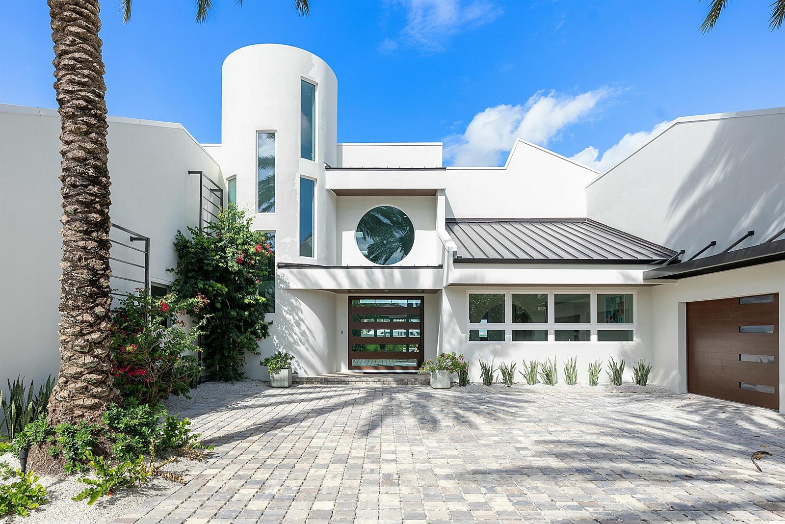 A modern white house with a circular window, a cylindrical tower, and a paved driveway — 6879 SE South Marina Way, Stuart FL 34996, STUART, FL