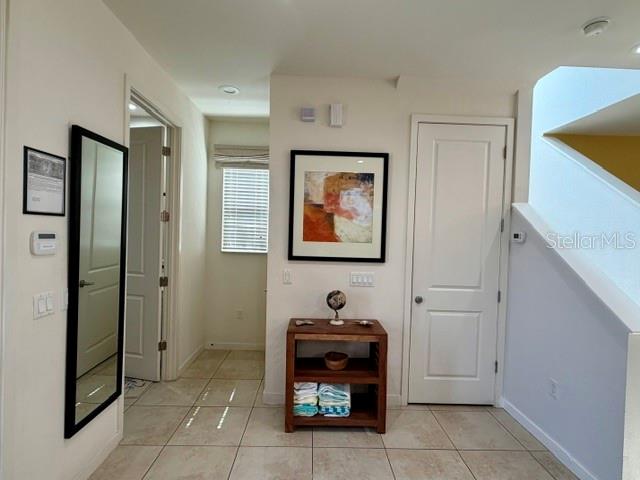 A hallway features tiled floors, a mirror, a wooden console table, and a closed door — 5758 LESABRE DRIVE, KISSIMMEE, FL