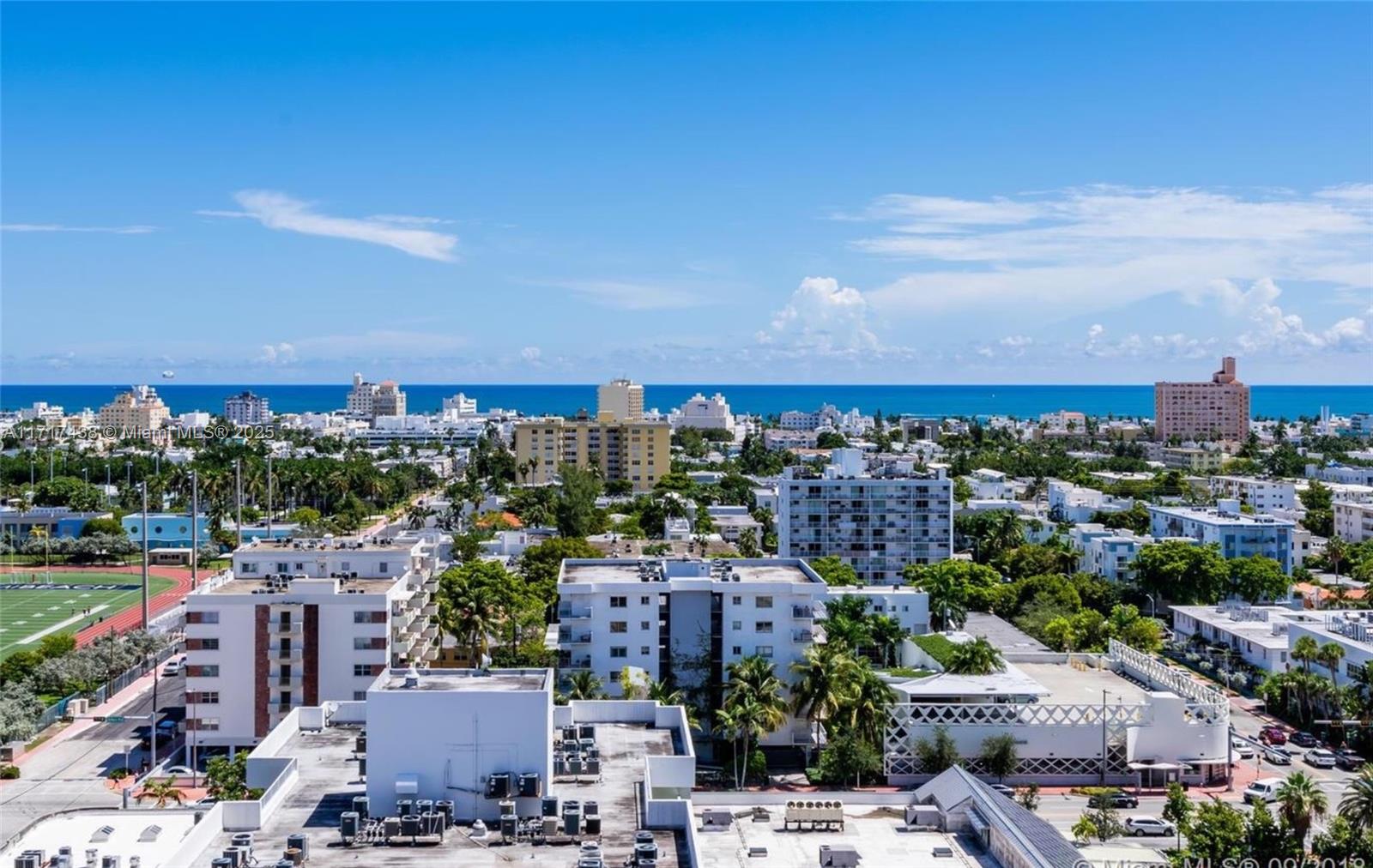 An elevated view of a coastal city with buildings, a sports field, and the ocean — 1000 West Ave # 07, Miami Beach FL 33139, MIAMI BEACH, FL