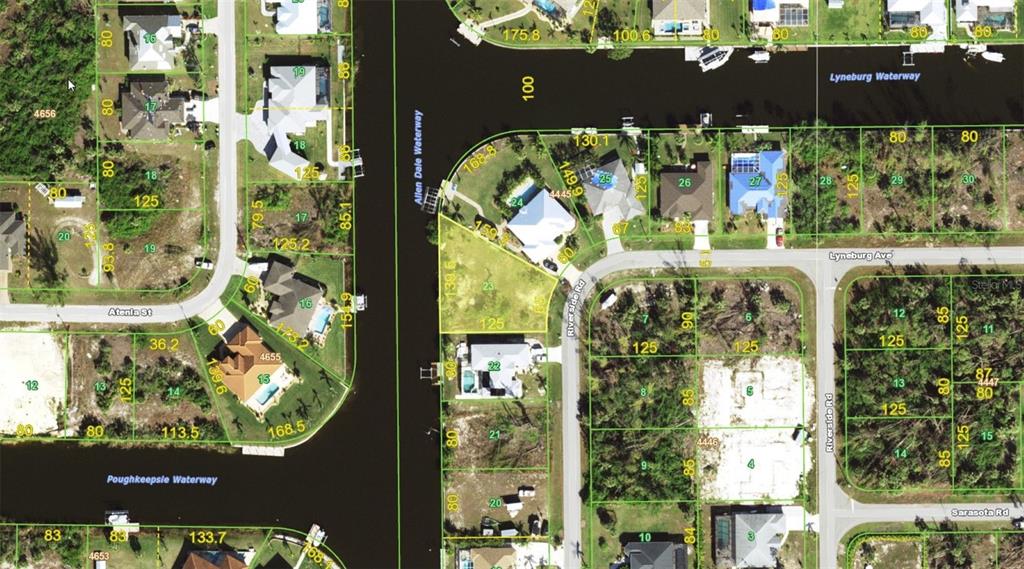 This is a satellite map view showing residential lots, streets, and waterways — 10610 RIVERSIDE ROAD, PORT CHARLOTTE, FL