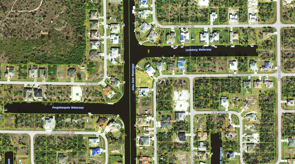 This is a satellite map view showing residential lots, streets, and waterways in a neighborhood — 10610 RIVERSIDE ROAD, PORT CHARLOTTE, FL
