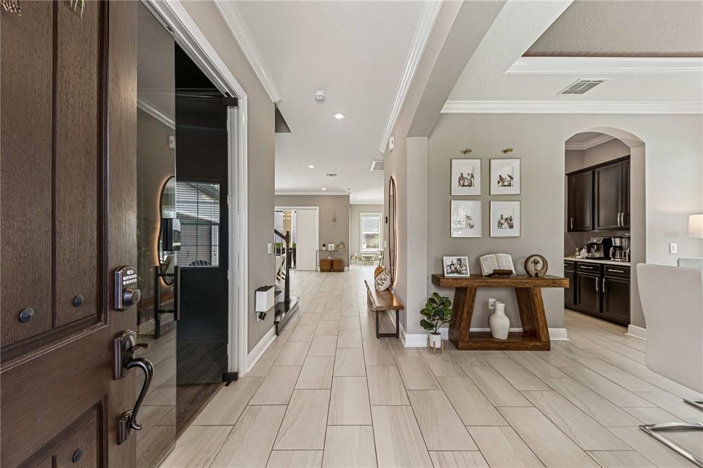 A view from an entryway looking into a home with tile floors and a console table — 9225 HOLLISTON CREEK PLACE, WINTER GARDEN, FL