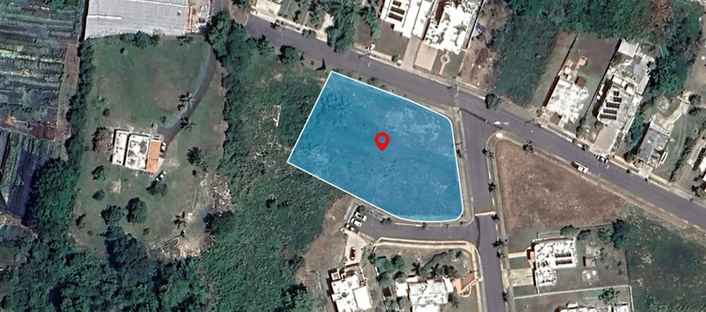 An aerial view shows a vacant, irregularly shaped plot of land highlighted in blue — . HACIENDAS DE CAMUY, BO. PUENTE, SOLAR 11, CAMUY, PR