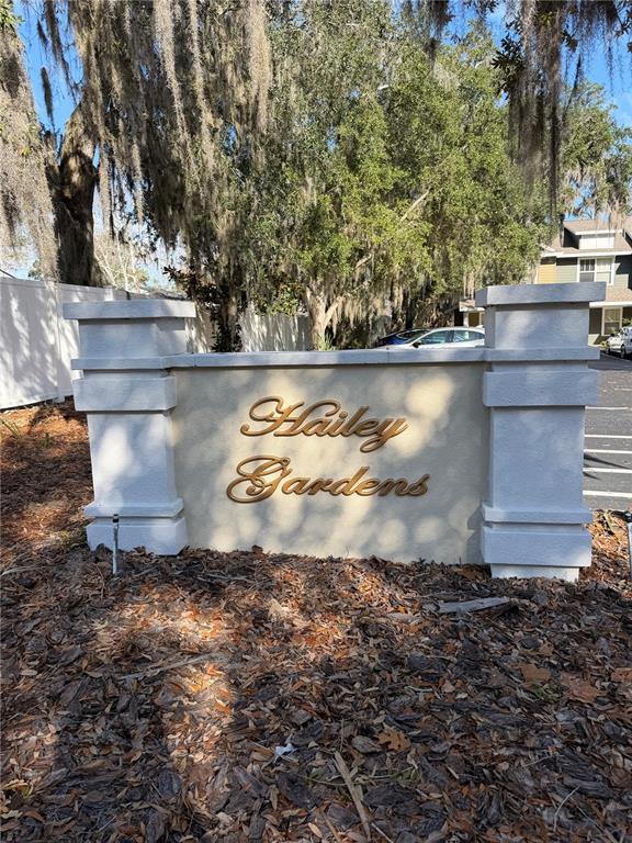 A stone monument sign for Hailey Gardens stands in front of trees and a parking lot — 2306 SW 42ND DRIVE UNIT 140, GAINESVILLE, FL