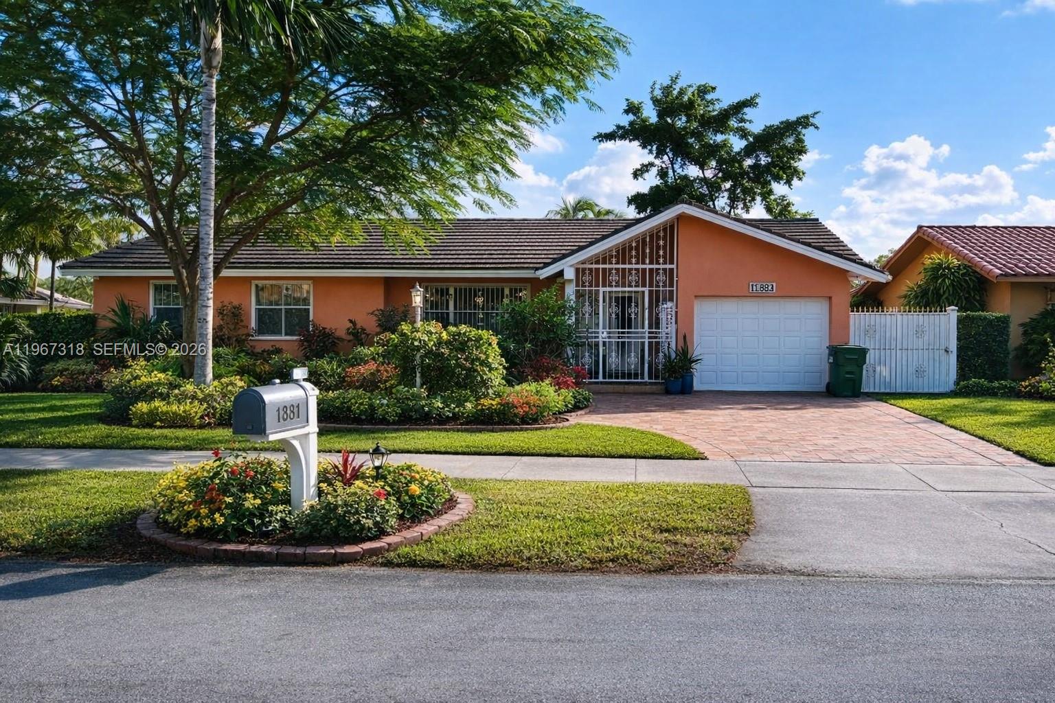 A single-story house with an orange exterior, a tiled roof, and a paved driveway — 13108 SW 3rd St, Miami FL 33184, MIAMI, FL
