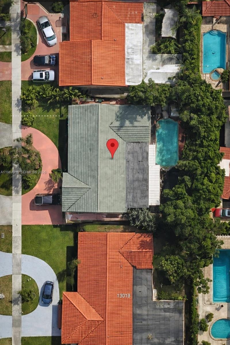 This aerial view shows a residential property with a swimming pool and surrounding houses — 13108 SW 3rd St, Miami FL 33184, MIAMI, FL