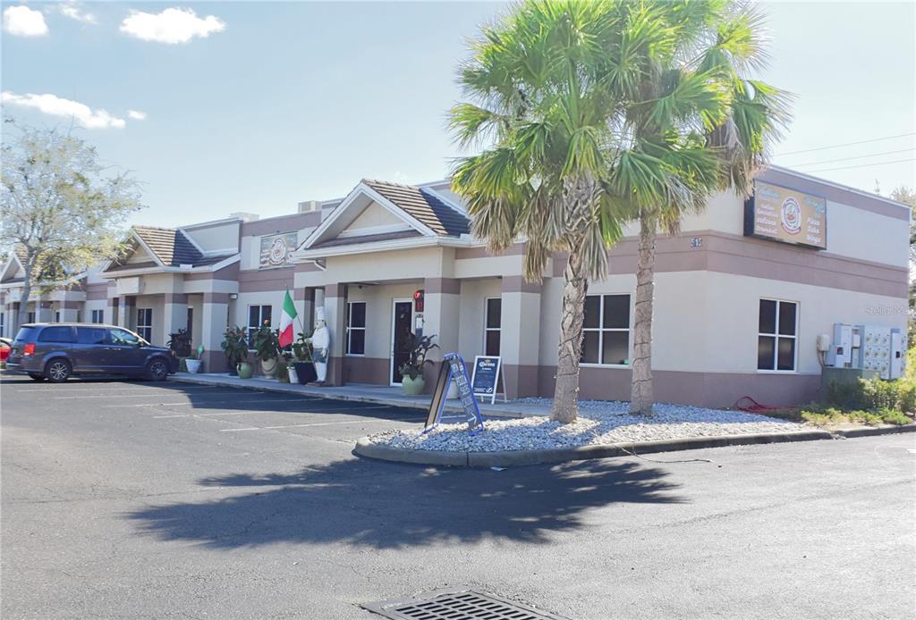 A single-story commercial building with a parking lot and palm trees in front — 515 27TH STREET E UNIT 9, 10, 11, BRADENTON, FL