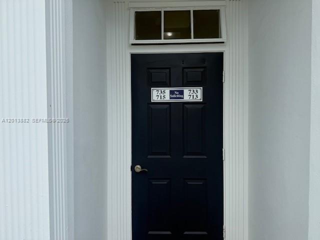 A dark blue front door with a transom window and unit numbers is set in white — 170 Cypress Club Dr # 733, Pompano Beach FL 33060, POMPANO BEACH, FL