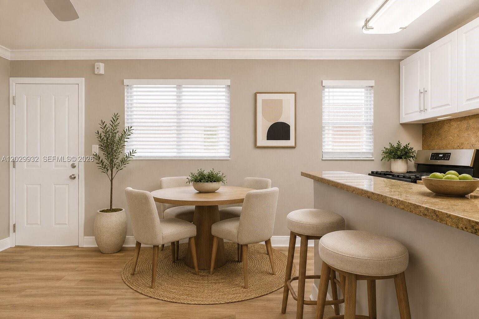 A dining area with a round table, four chairs, and a kitchen breakfast bar — 1014 Salzedo St # 211, Coral Gables FL 33134, CORAL GABLES, FL