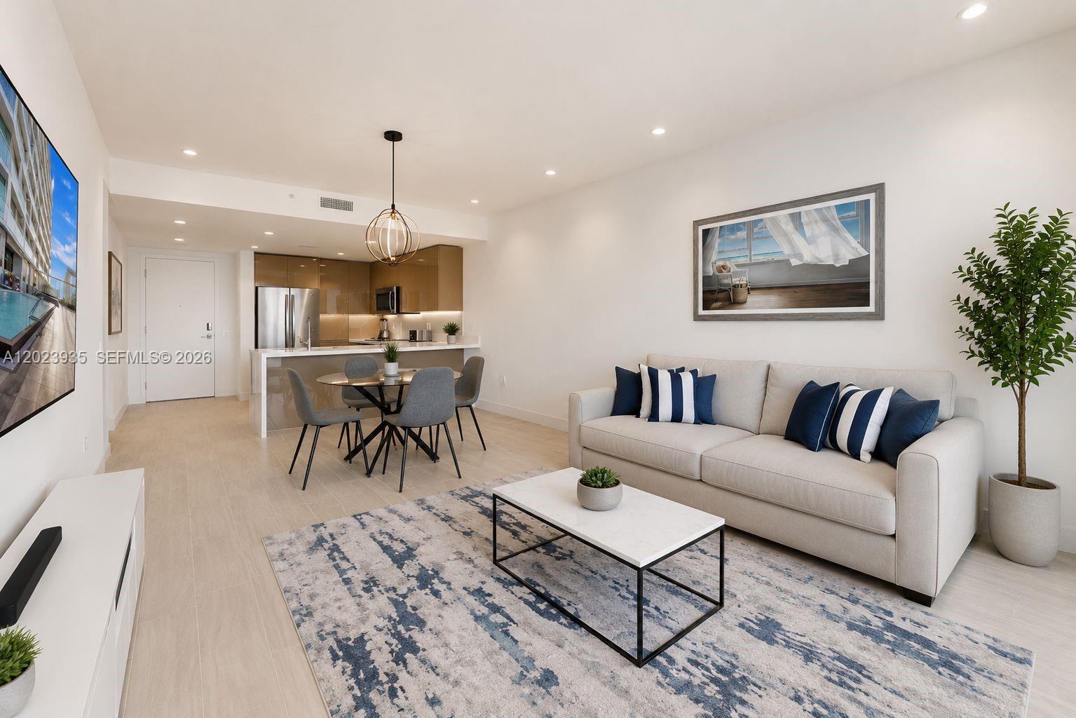 A modern living room and dining area feature light tile floors and neutral furniture — 2000 Metropica Way # 1408, Sunrise FL 33323, SUNRISE, FL