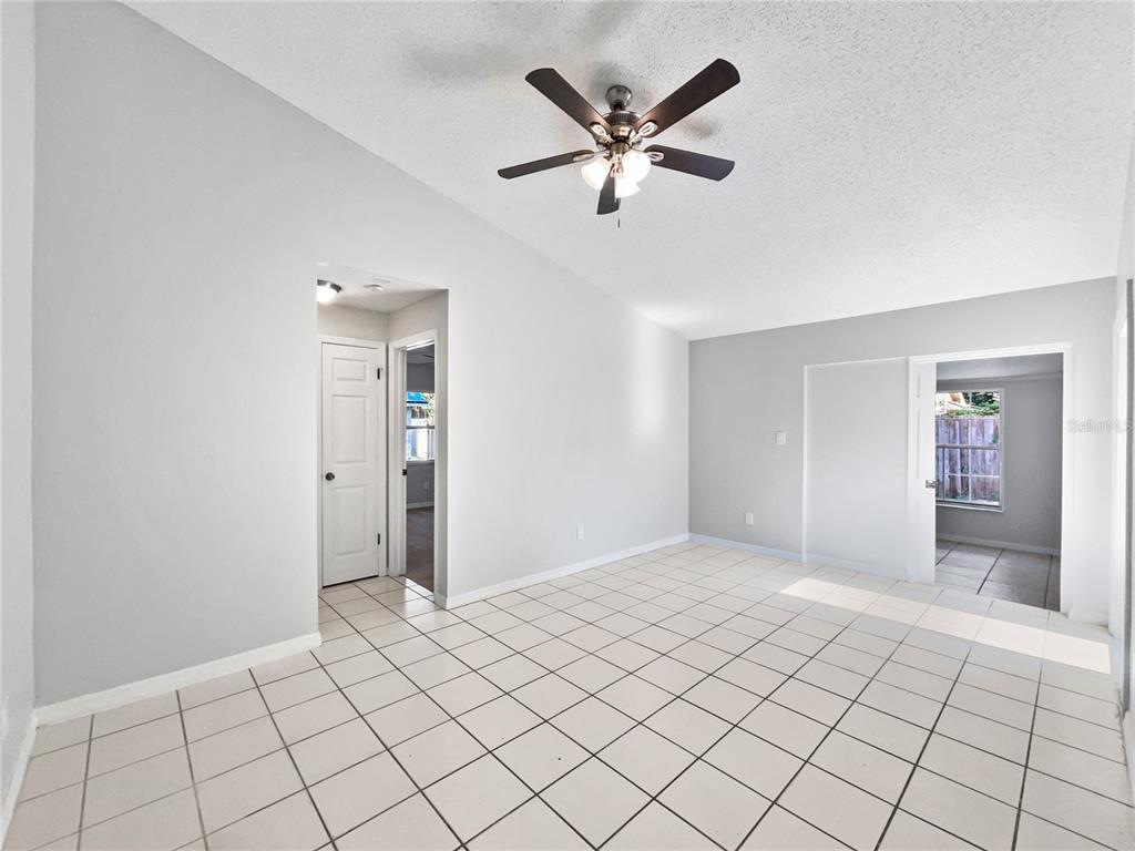 A room with white tiled floors, light gray walls, and a ceiling fan — 831 HAULOVER DRIVE, ALTAMONTE SPRINGS, FL