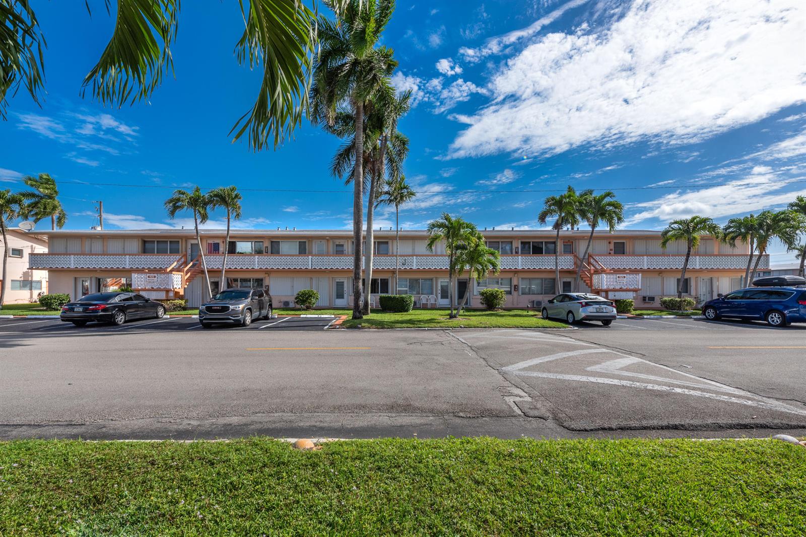 A two-story apartment building with palm trees and parked cars in front — 925 SW 11th Avenue # 3j, FL 33009, FL