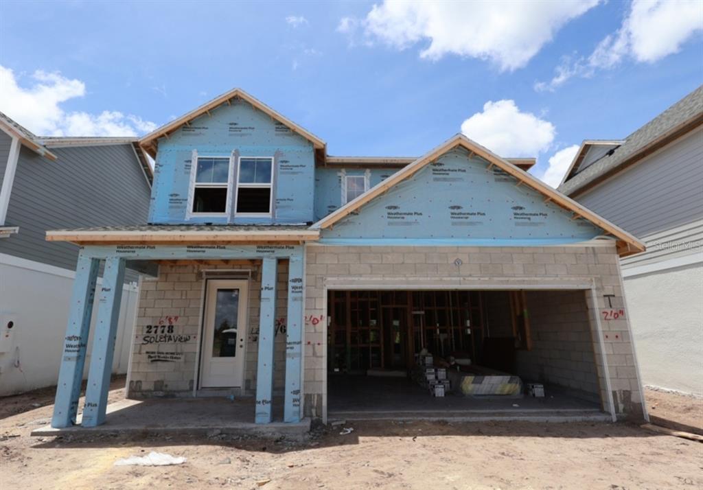 A two-story house under construction with a concrete block exterior and an open garage — 2778 SOLETA VIEW, ODESSA, FL