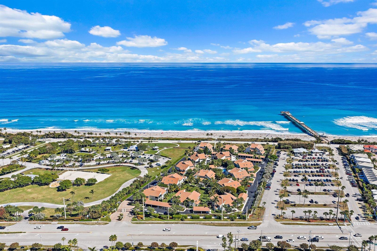 An aerial view shows a coastal condominium complex with a parking lot near a beach pier — 4161 S Us Highway 1 # E3, Jupiter FL 33477, JUPITER, FL