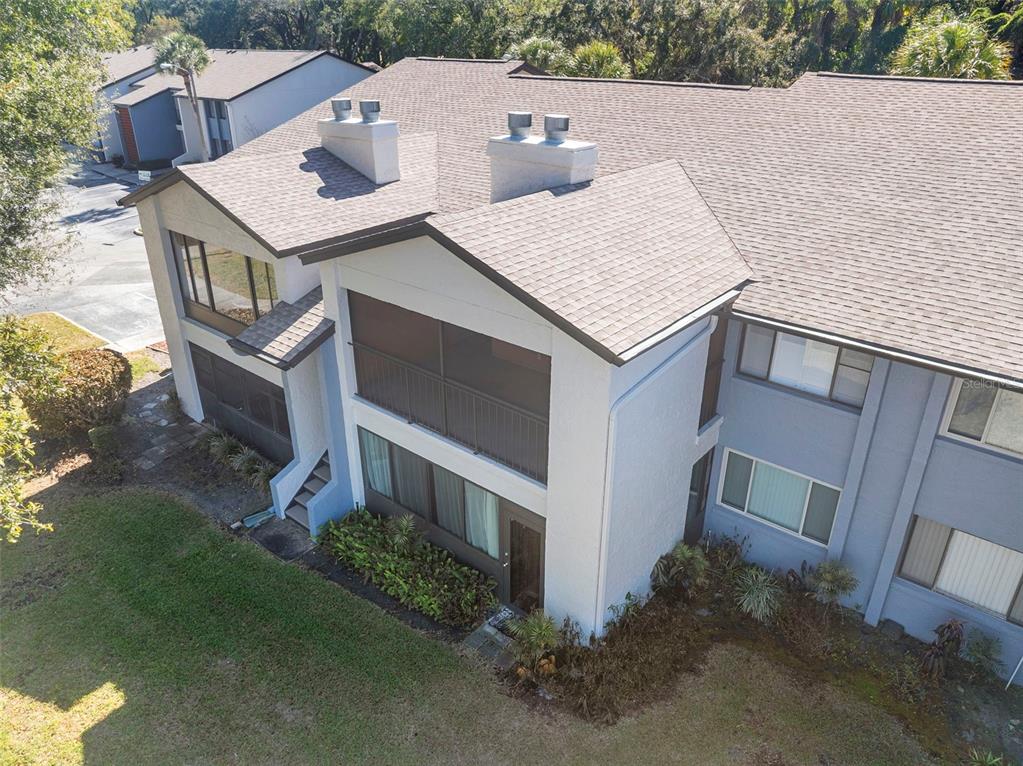 An aerial view of a two-story residential building with a screened balcony and shingled roof — 5 ESCONDIDO CIRCLE UNIT 46, ALTAMONTE SPRINGS, FL