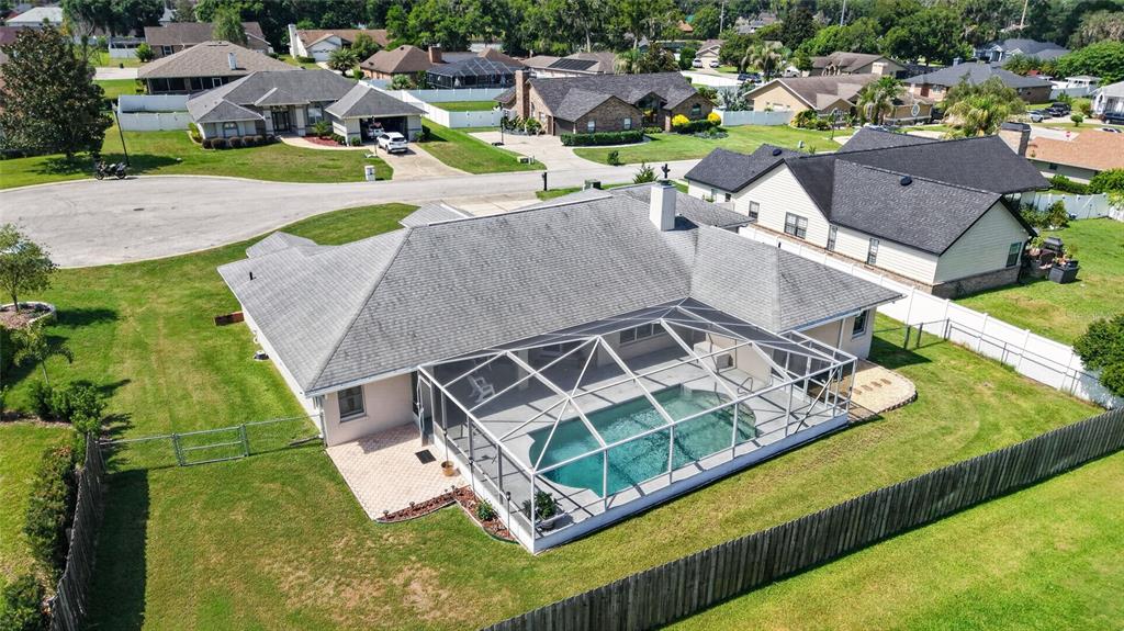 An aerial view shows a single-story house with a screened-in pool and a fenced backyard — 2319 SE 30TH STREET, OCALA, FL