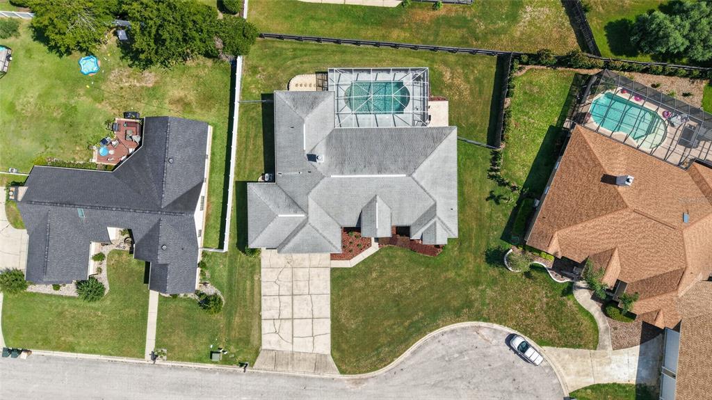 An aerial view shows three suburban houses with pools and driveways in a residential neighborhood — 2319 SE 30TH STREET, OCALA, FL