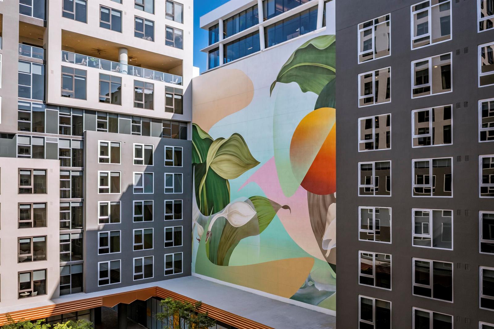 A large, colorful botanical mural spans the exterior wall between two modern apartment buildings — 286 NW 29th Street # 721, Miami FL 33127, MIAMI, FL