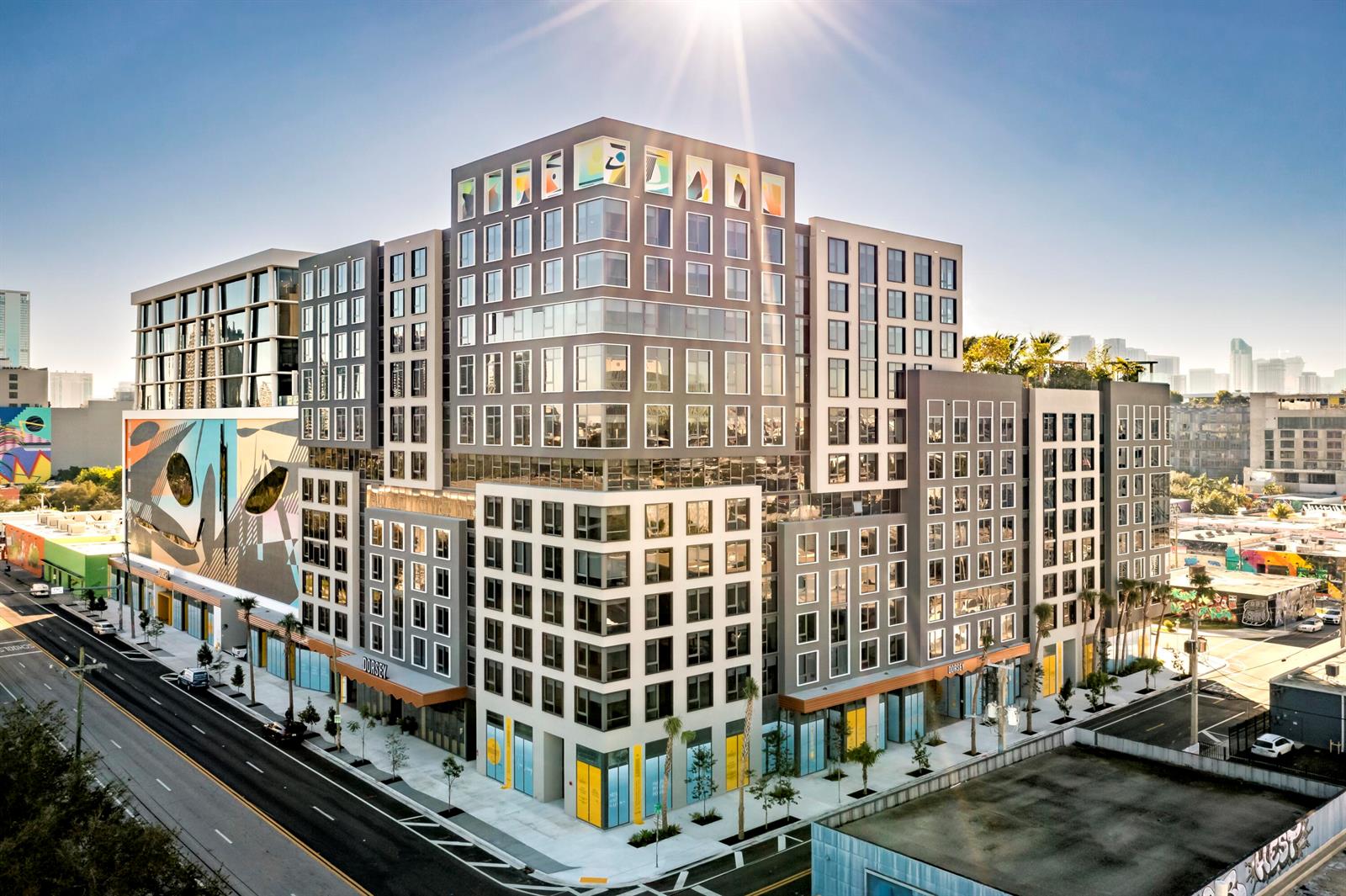 A modern, multi-story apartment building features a large mural and ground-level retail spaces — 286 NW 29th Street # 721, Miami FL 33127, MIAMI, FL