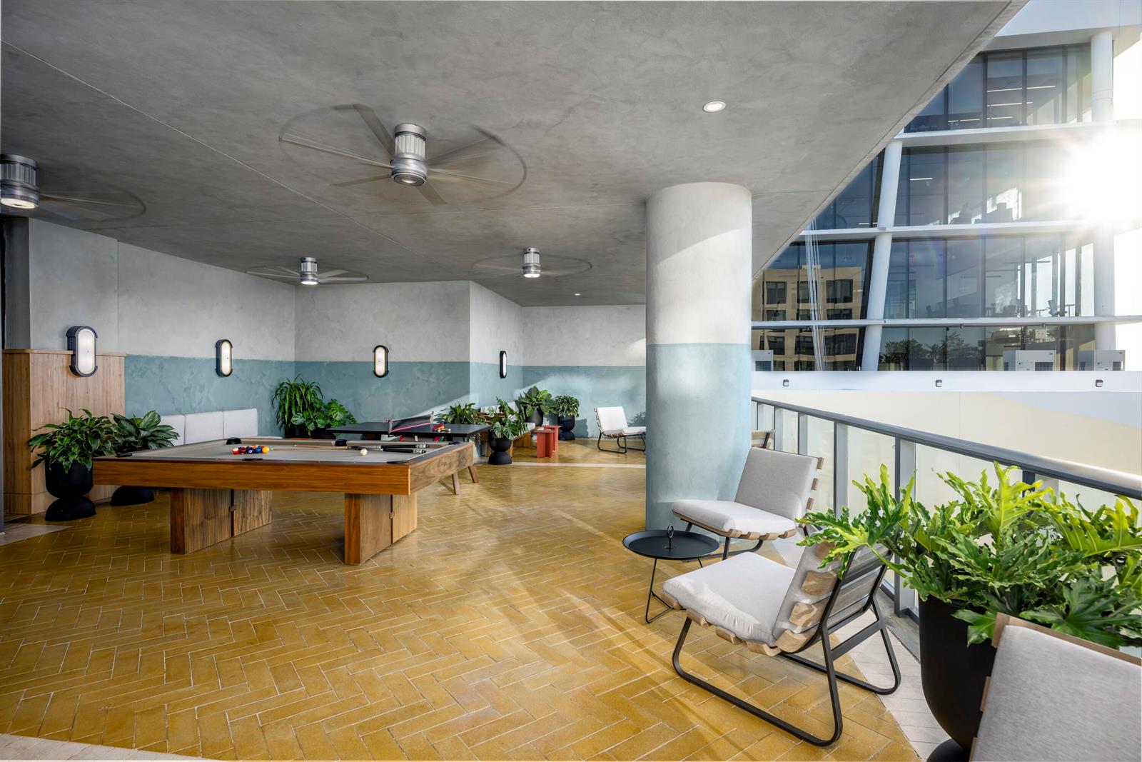 An outdoor covered patio features a pool table, lounge seating, and yellow herringbone tile flooring — 286 NW 29th Street # 721, Miami FL 33127, MIAMI, FL