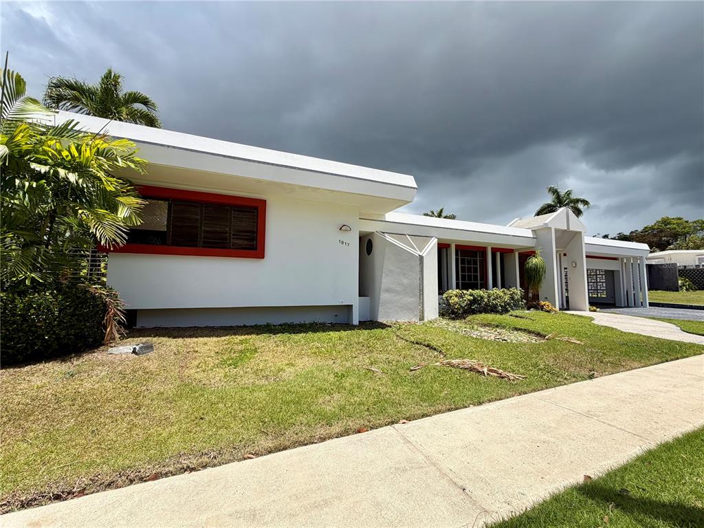 A white mid-century modern house with red window trim and a flat roof — 1917 ORQUIDEA, SAN JUAN, PR