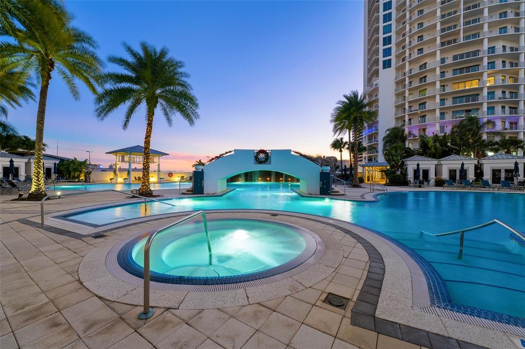 A resort-style swimming pool with a hot tub and a bridge at sunset — 1209 E CUMBERLAND AVENUE UNIT 501, TAMPA, FL