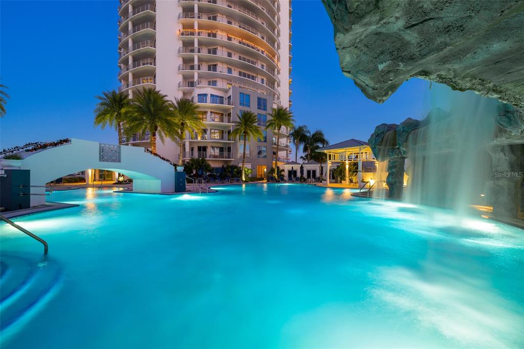A swimming pool with a waterfall feature and a bridge at a high-rise building — 1209 E CUMBERLAND AVENUE UNIT 501, TAMPA, FL