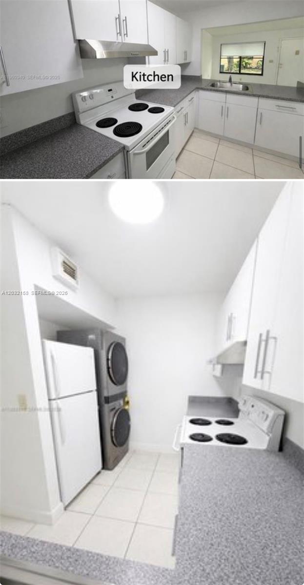 A kitchen featuring white cabinets, gray countertops, a white stove, and a stacked laundry unit — 2530 W 67th Pl # 29, Hialeah FL 33016, HIALEAH, FL