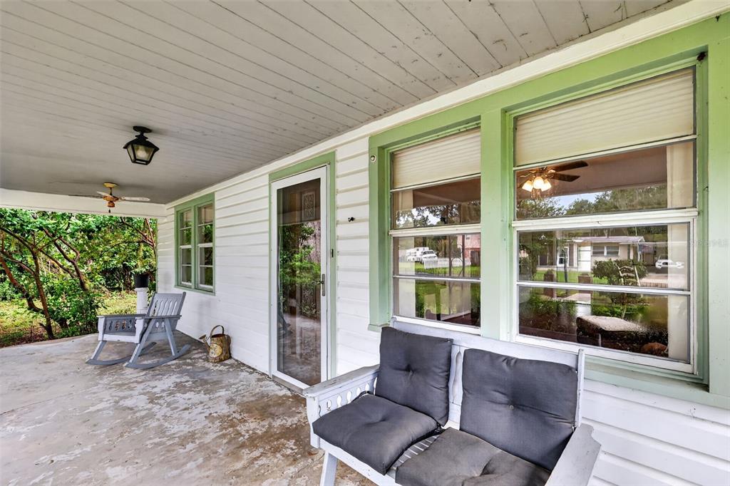 A living room features wood-look flooring, a white brick fireplace, and two brown armchairs — 605 STANLEY AVENUE, WILDWOOD, FL
