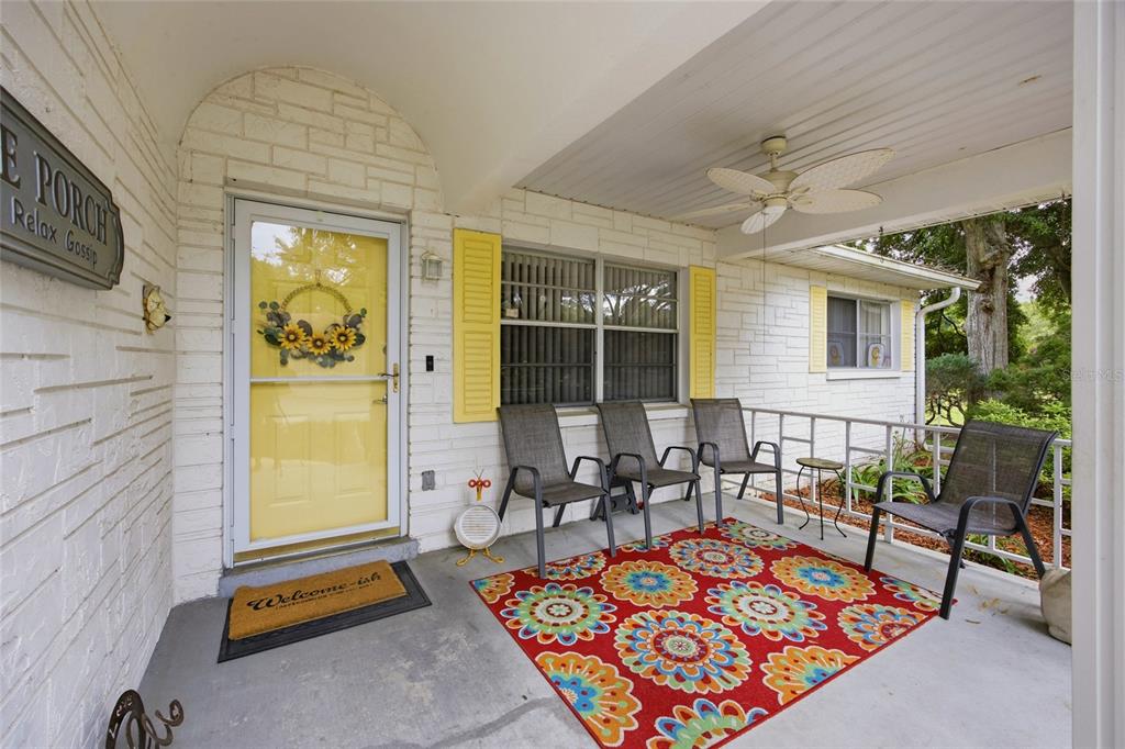 A bedroom features light wood flooring, a blue dresser, a bed, and a ceiling fan — 9335 SW 85TH TERRACE UNIT E, OCALA, FL