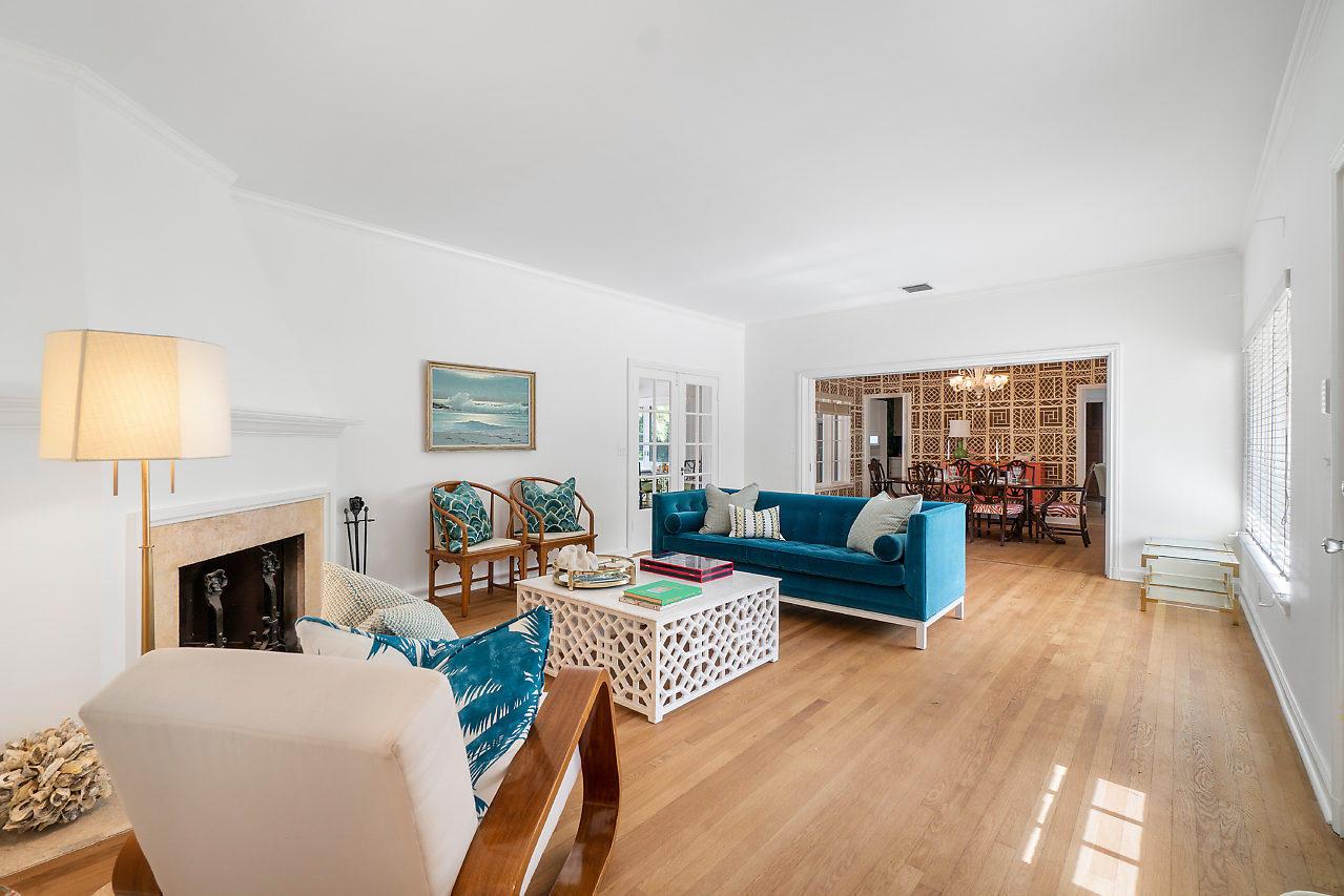A living room features a blue sofa, white coffee table, fireplace, and hardwood floors — 1008 N Ocean Boulevard, Gulf Stream FL 33483, GULF STREAM, FL