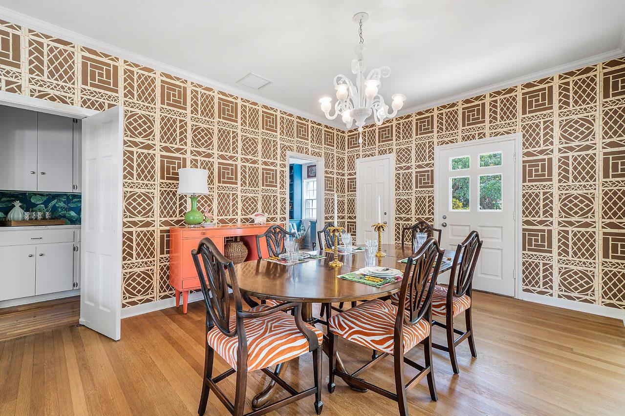 A dining room features patterned wallpaper, a wooden table with zebra-print chairs, and a chandelier — 1008 N Ocean Boulevard, Gulf Stream FL 33483, GULF STREAM, FL
