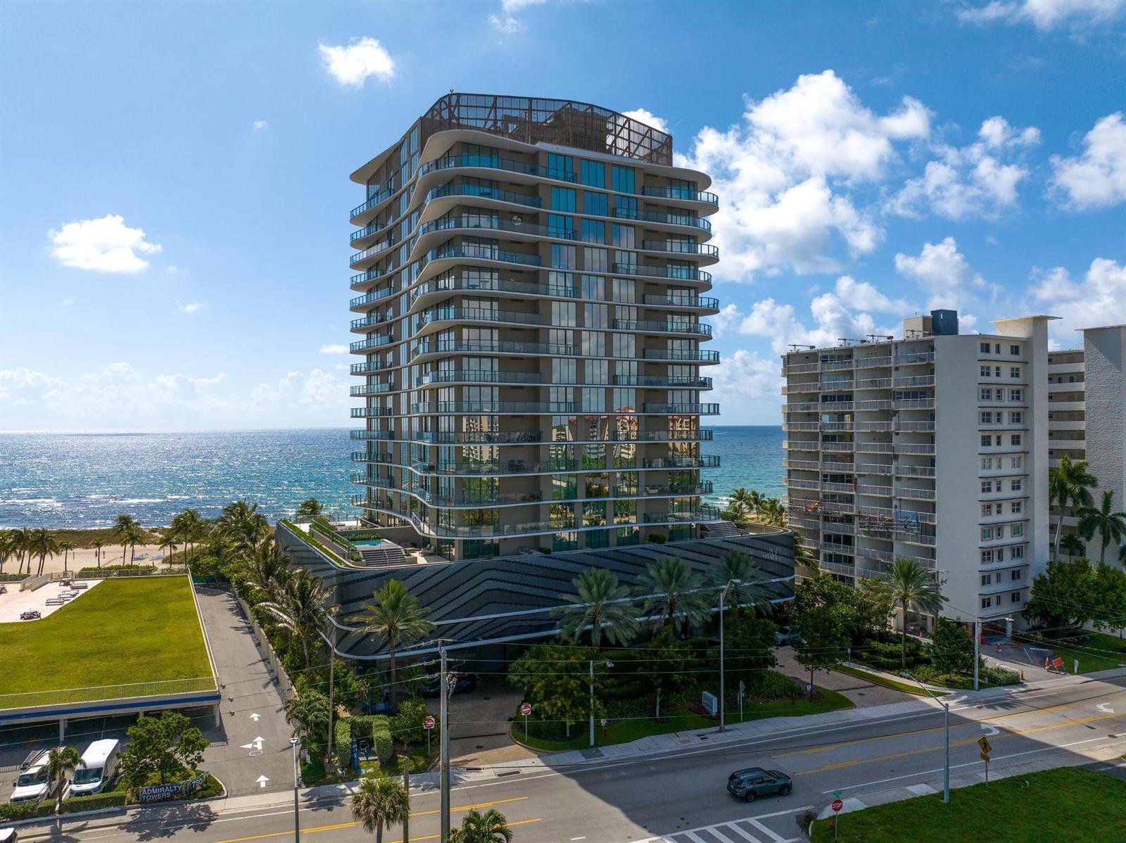 An aerial view of a modern high-rise residential building located next to the ocean — 730 N Ocean Boulevard # 405, Pompano Beach FL 33062, POMPANO BEACH, FL