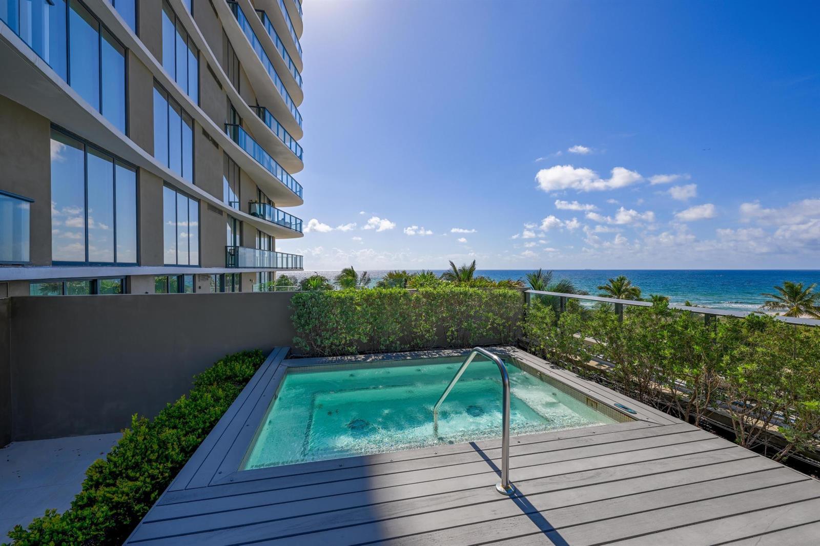 A private hot tub sits on a wooden deck overlooking the ocean next to a building — 730 N Ocean Boulevard # 405, Pompano Beach FL 33062, POMPANO BEACH, FL