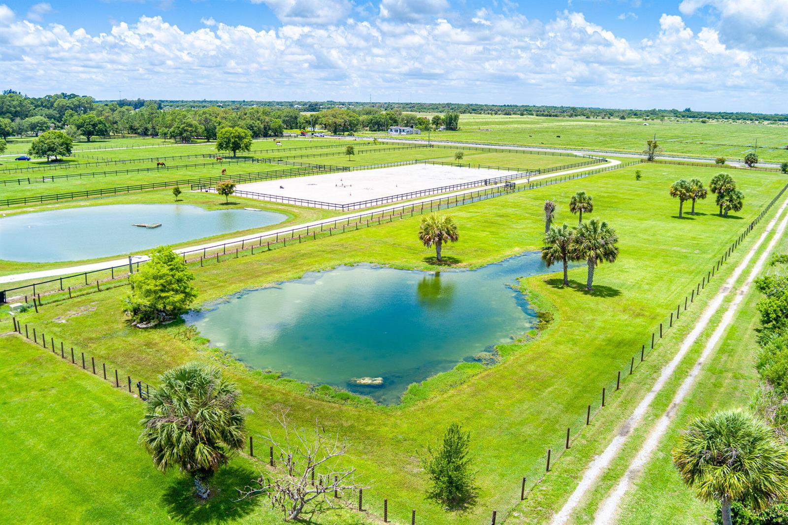 An aerial view shows a rural property with two ponds, a riding arena, and pastures — 3768 Seminole Road, Fort Pierce FL 34951, FORT PIERCE, FL