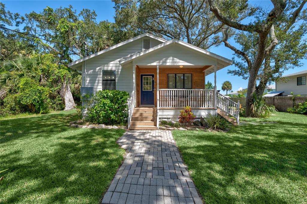 A single-story house with white siding, a front porch, and a stone walkway — 3 BAY DRIVE, PALM COAST, FL