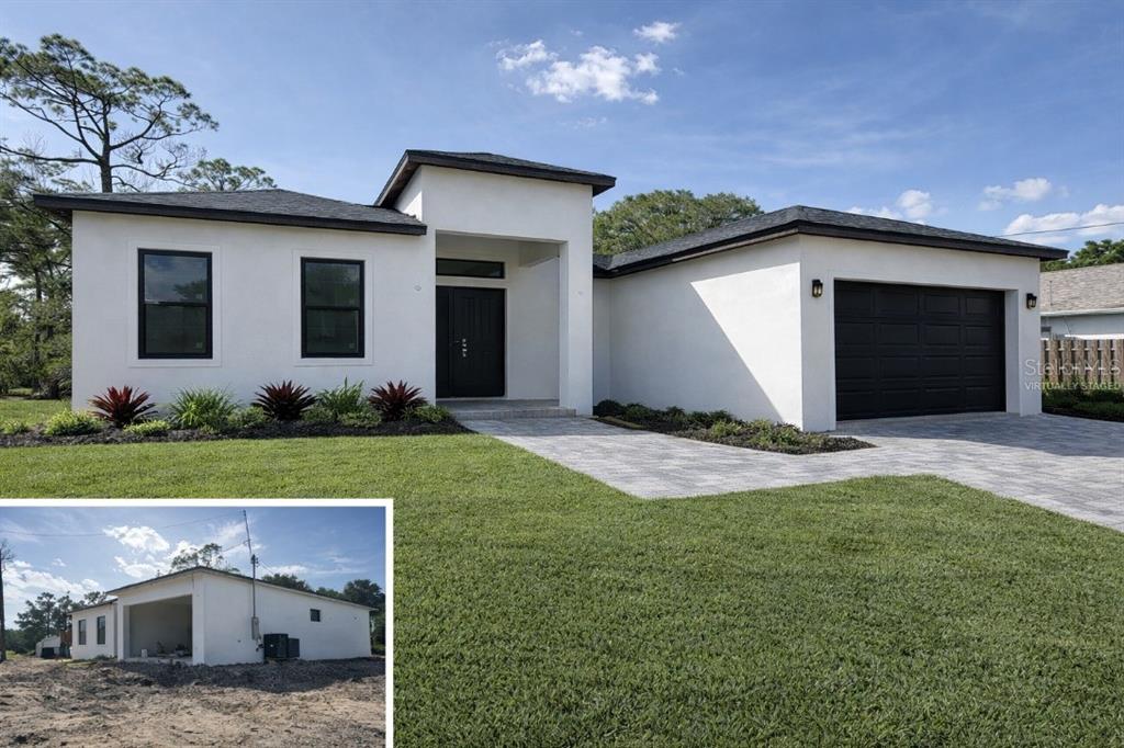 A modern white single-story house with a black garage door and a paved driveway — 3407 CULPEPPER TERRACE, NORTH PORT, FL