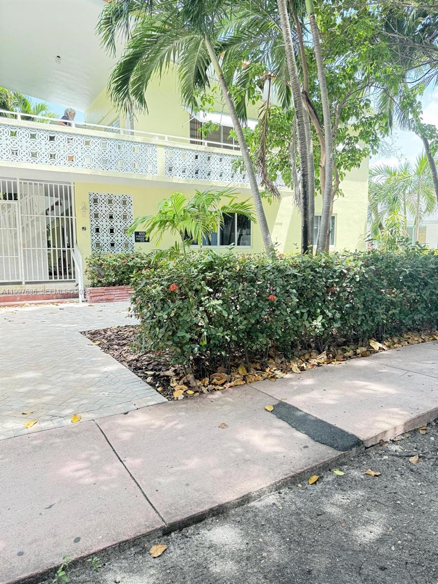 A two-story yellow building features a decorative white balcony railing and a paved walkway — 655 Meridian Ave # 2, Miami Beach FL 33139, MIAMI BEACH, FL