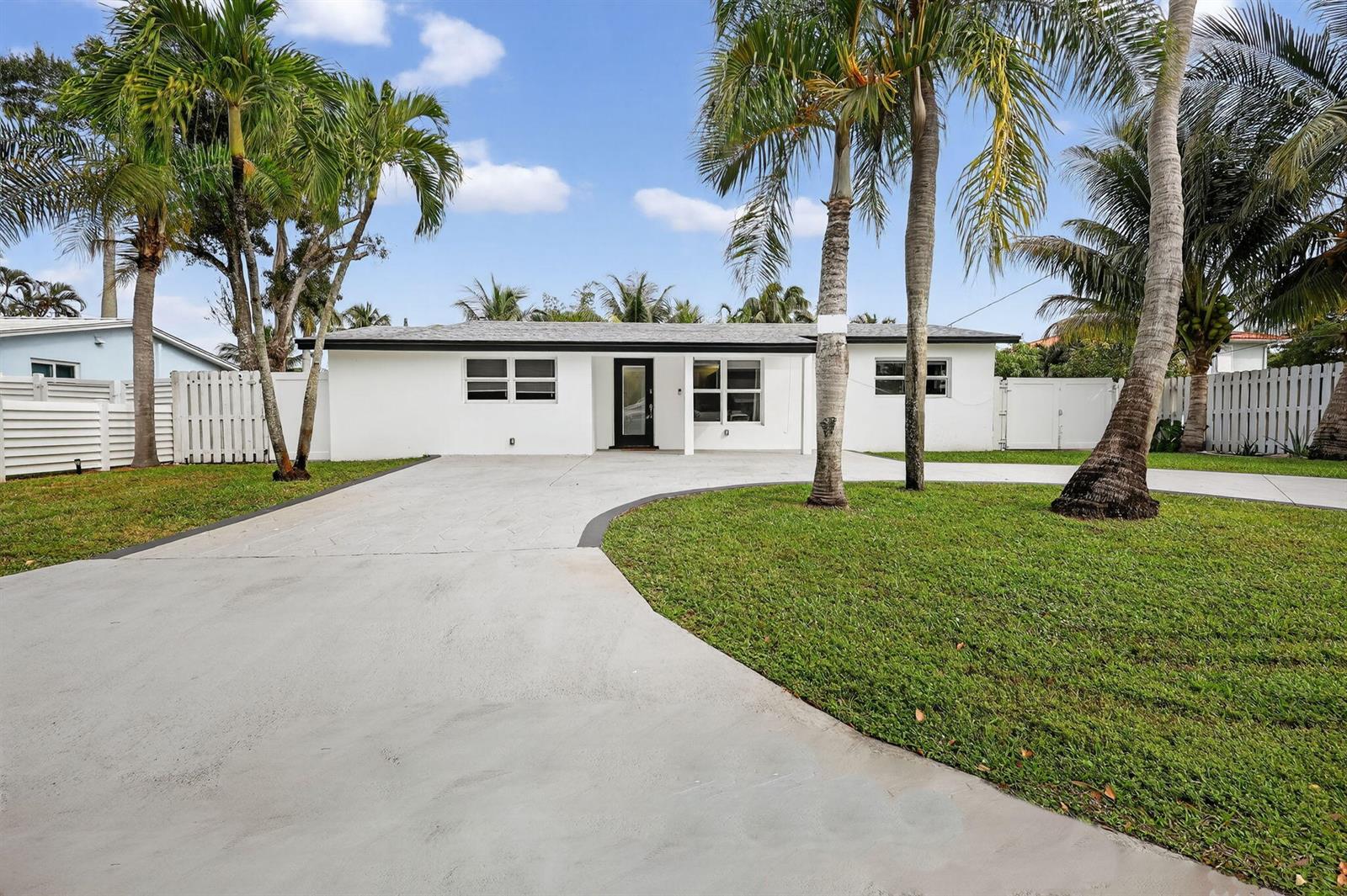 A white, single-story house with a concrete driveway and palm trees in the front yard — 4540 SW 28th Terrace, Dania Beach FL 33312, DANIA BEACH, FL