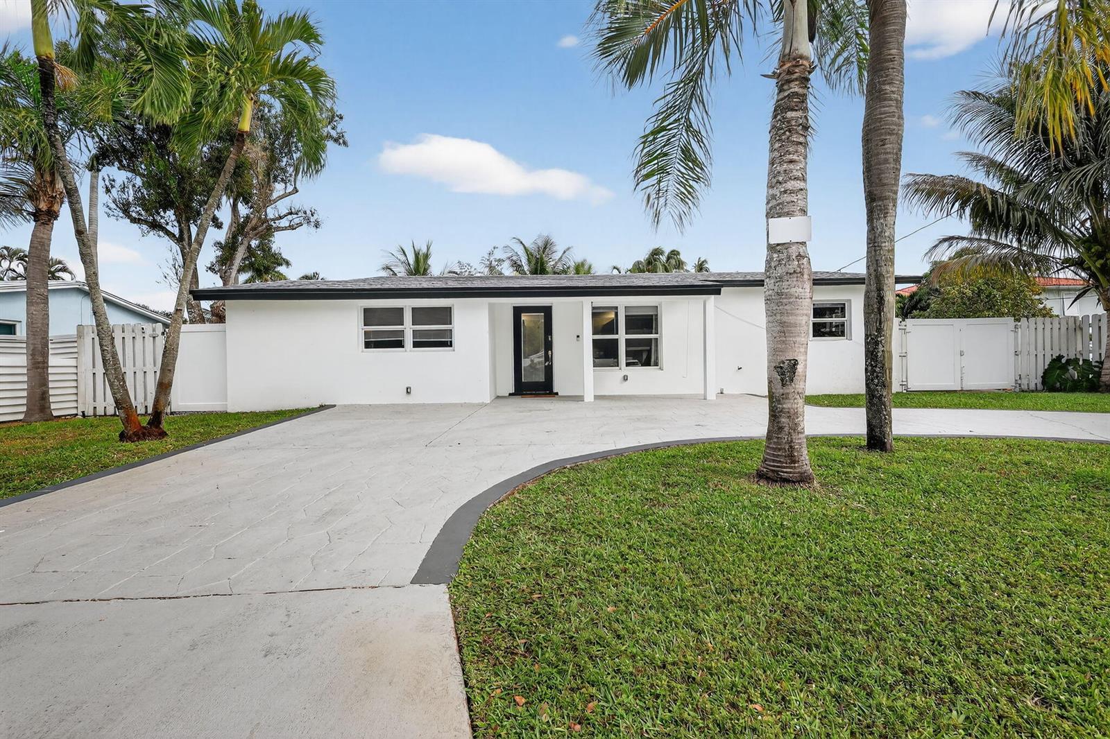 A single-story white house with a black front door and a concrete driveway — 4540 SW 28th Terrace, Dania Beach FL 33312, DANIA BEACH, FL