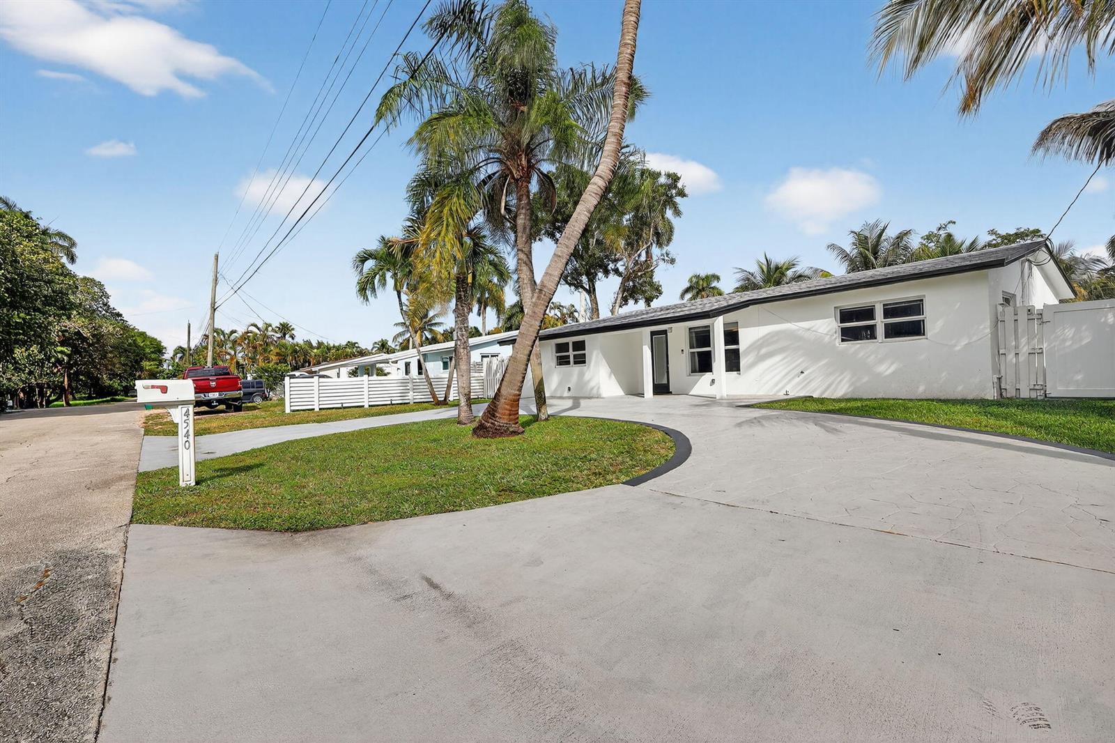 A white single-story house with a curved concrete driveway and palm trees in the yard — 4540 SW 28th Terrace, Dania Beach FL 33312, DANIA BEACH, FL