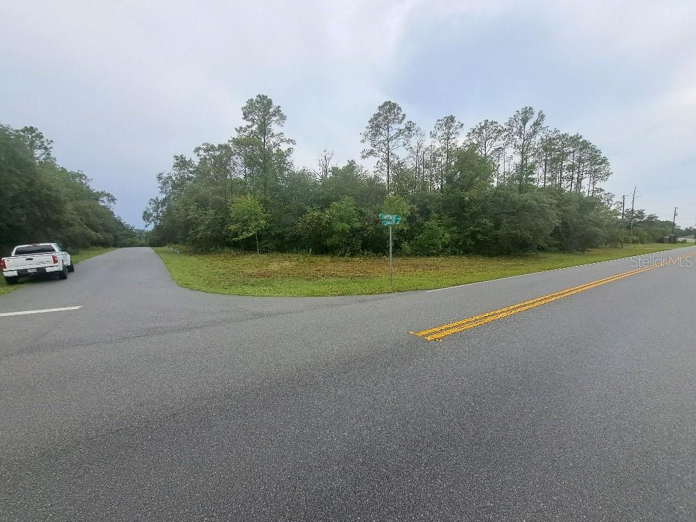 A corner lot with a street sign and a white pickup truck parked nearby — 6344 N CAVALIER TERRACE, CITRUS SPRINGS, FL