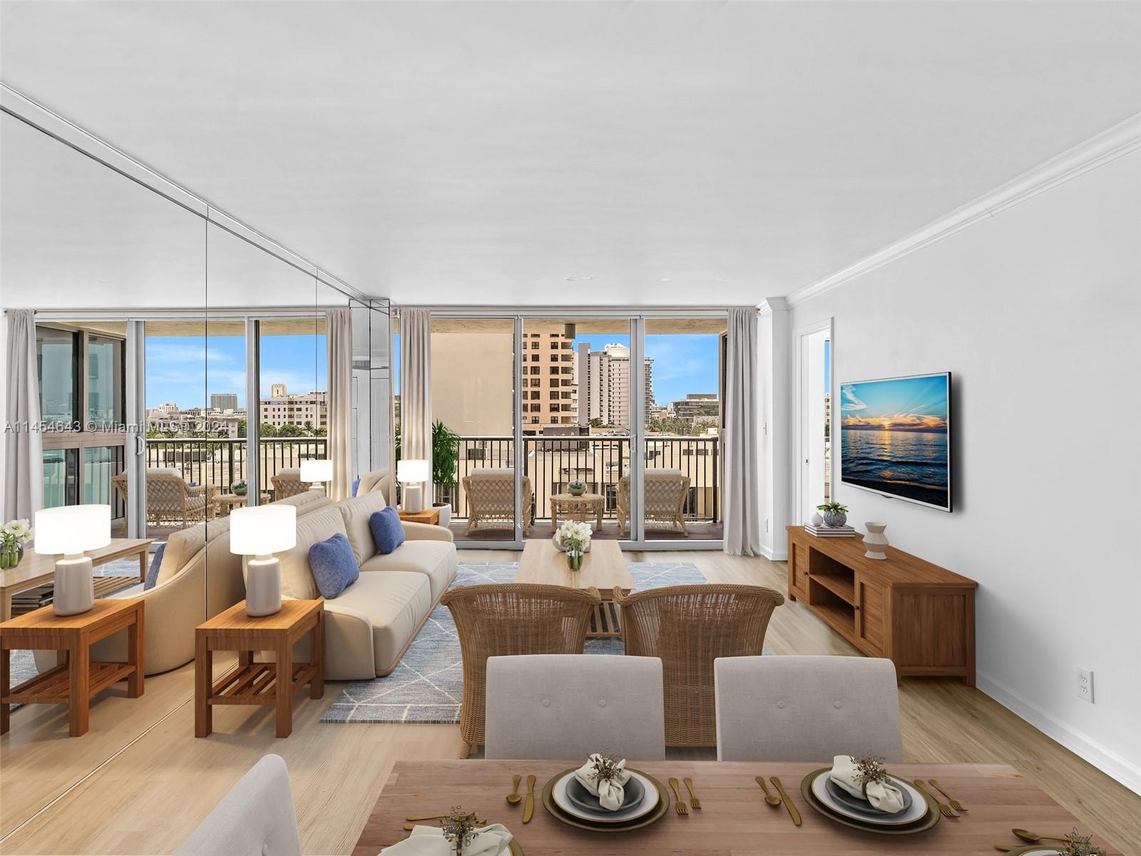 A living room with a beige sofa, wicker chairs, and a mirrored wall facing a balcony — 2655 Collins Ave # 706, Miami Beach FL 33140, MIAMI BEACH, FL