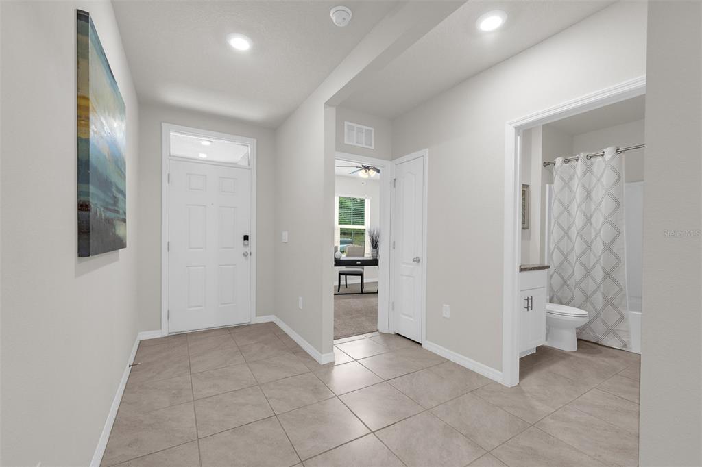 An entryway with tile flooring leads to a bathroom, a closet, and a living area — 505 LADY IRELYN COURT, DELAND, FL