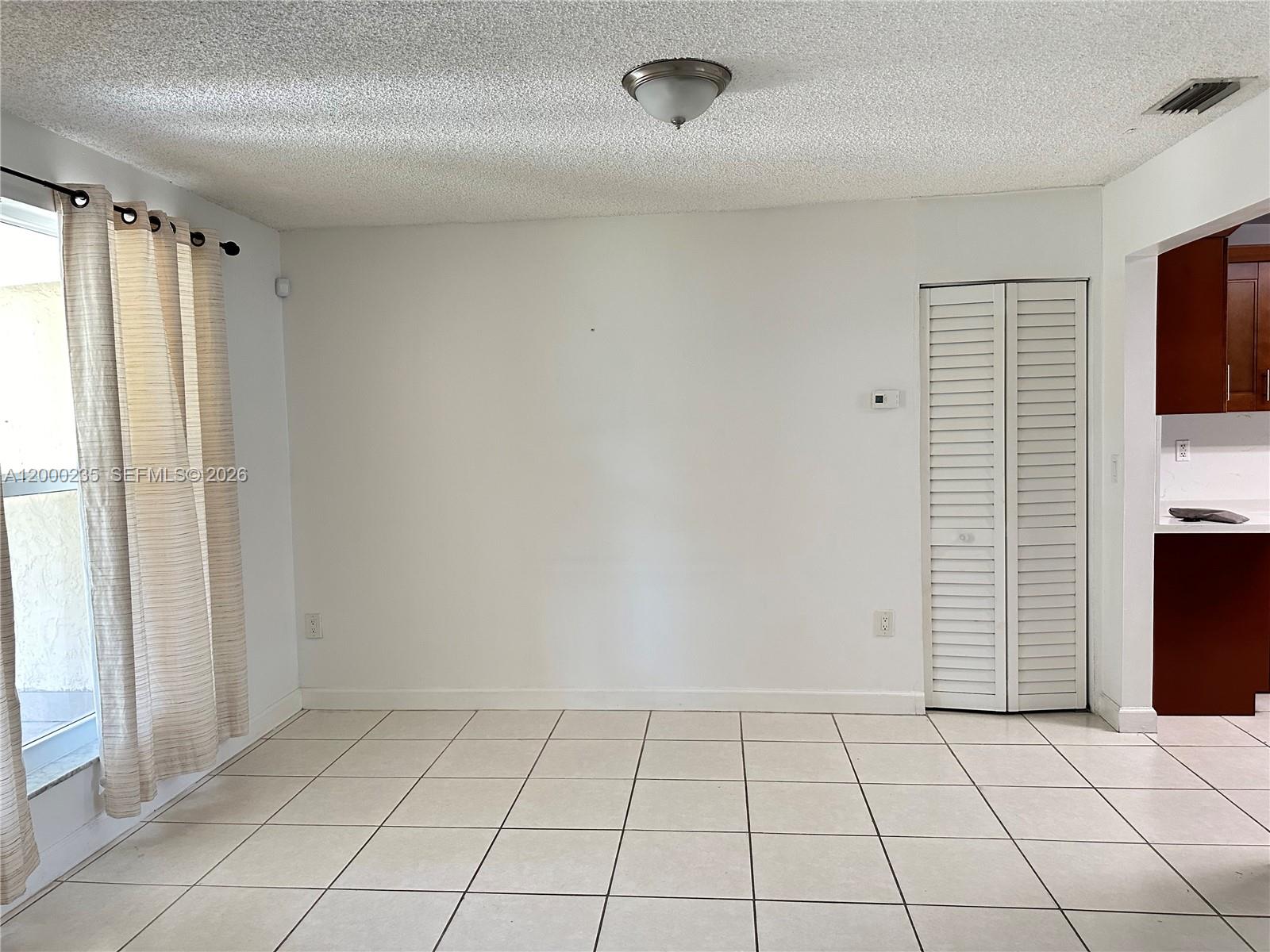 A room with white walls, tiled floors, a ceiling light, and a white louvered closet door — 17335 SW 108th Ct, Miami FL 33157, MIAMI, FL