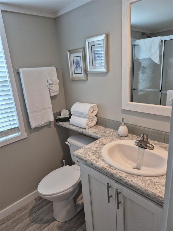 A bathroom features a vanity with a stone countertop, a toilet, and a framed mirror — 0 HIGHWAY 630 E UNIT 320, LAKE WALES, FL