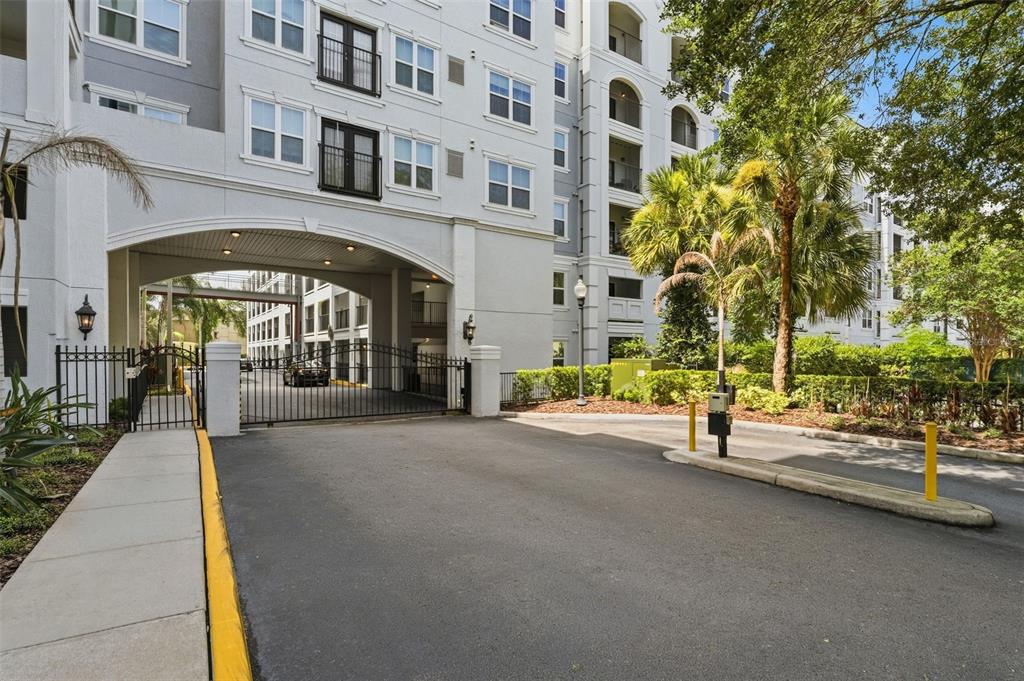 The exterior of a multi-story apartment building features an arched entryway labeled The Grande — 202 E SOUTH STREET UNIT 3036, ORLANDO, FL
