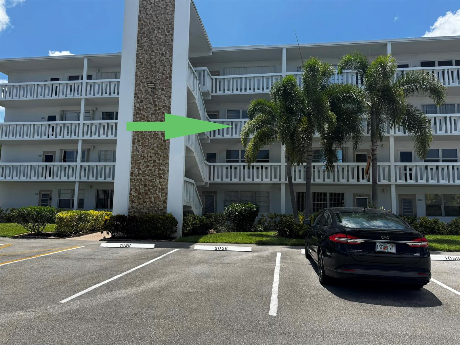 A multi-story apartment building with white balconies and a textured stone pillar exterior — 3058 Cambridge C # 3058, Deerfield Beach FL 33442, DEERFIELD BEACH, FL