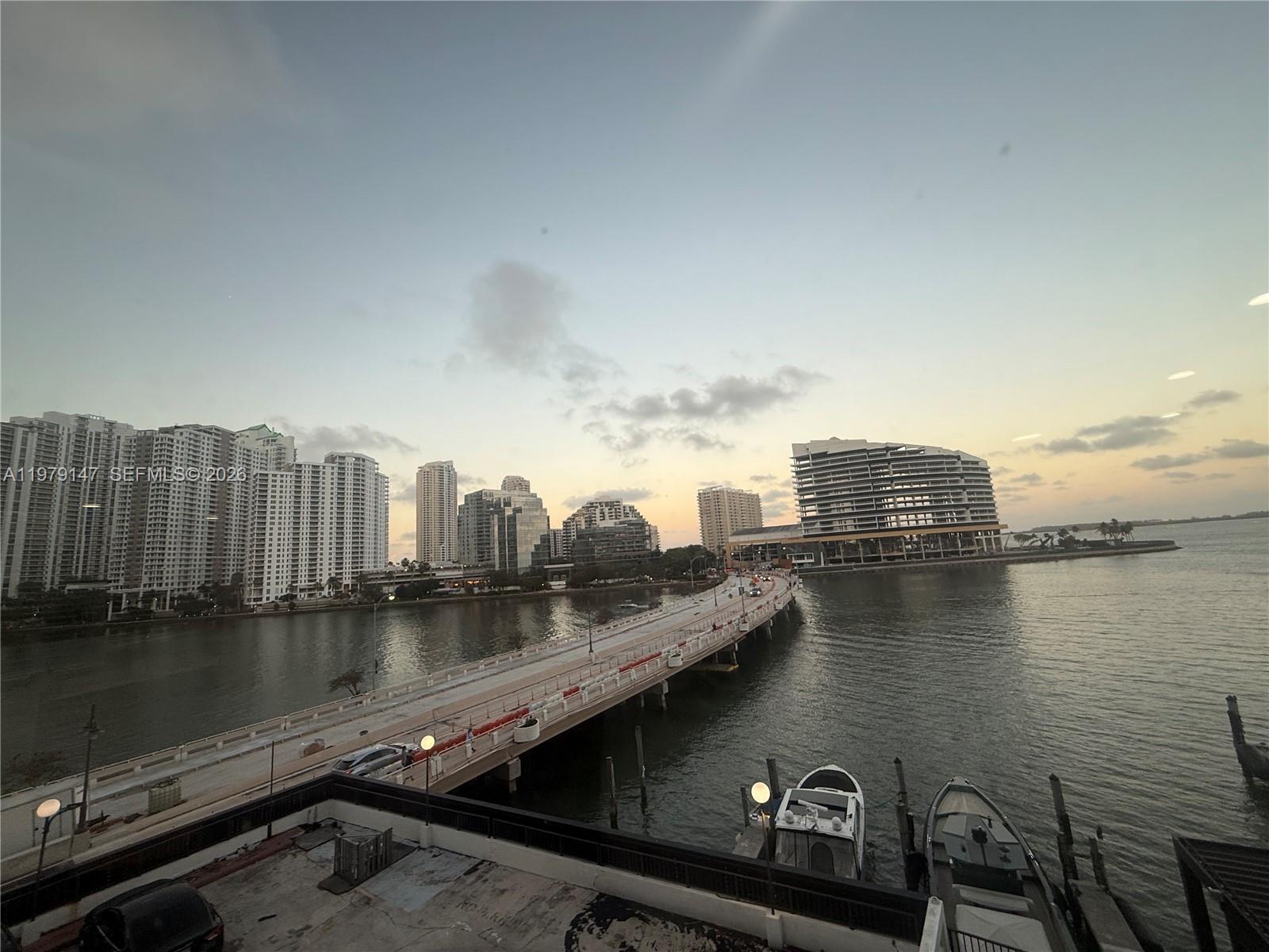 A view of a bridge over water with high-rise buildings and boats at sunset — 801 Brickell Bay Dr # 470, Miami FL 33131, MIAMI, FL
