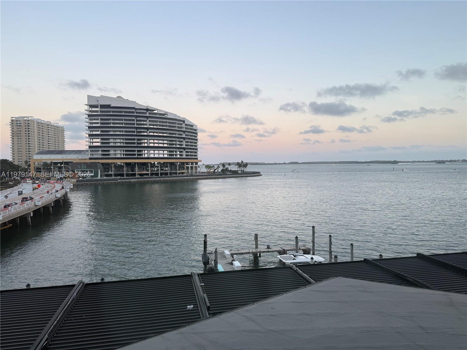 An exterior view shows a waterfront building under construction next to a boat dock — 801 Brickell Bay Dr # 470, Miami FL 33131, MIAMI, FL